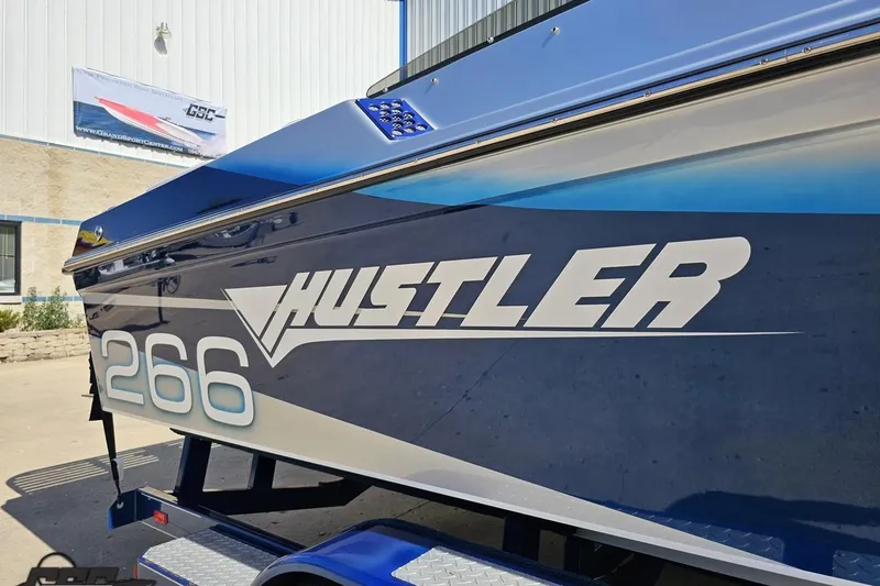 Slide: The Image of Blue 2010 Hustler 266 Classic boat on trailer, side view. - 7