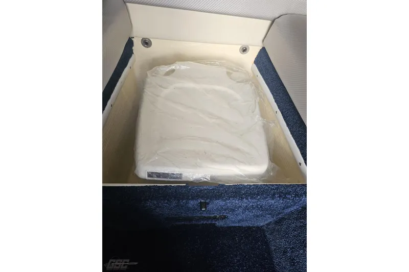 Slide: The Image of Storage compartment in 2010 Hustler 266 Classic boat, featuring a wrapped cushion. - 70