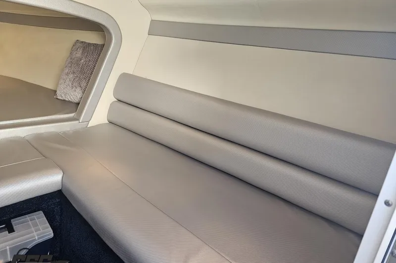 Slide: The Image of Interior of 2010 Hustler 266 Classic boat with cushioned seating and pillow. - 71