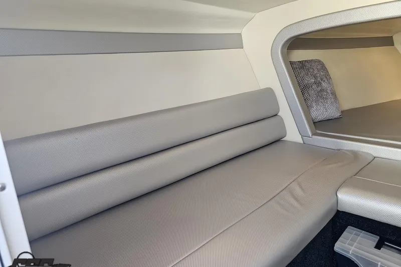 Slide: The Image of Interior of a 2010 Hustler 266 Classic boat with gray seating and modern design. - 72