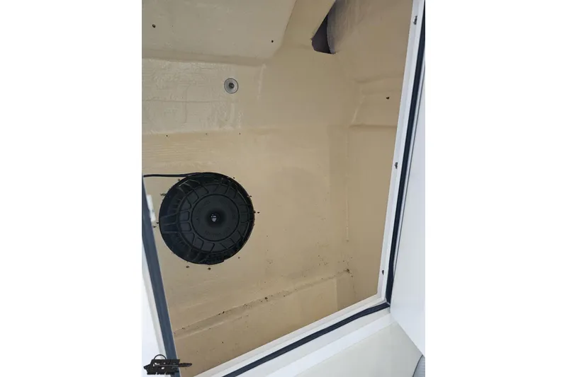 Slide: The Image of 2010 Hustler 266 Classic boat interior storage compartment with speaker. - 74