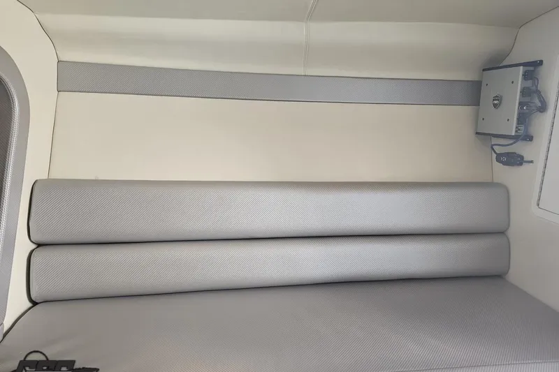 Slide: The Image of Interior seating of 2010 Hustler 266 Classic boat, featuring gray upholstery and sleek design. - 75