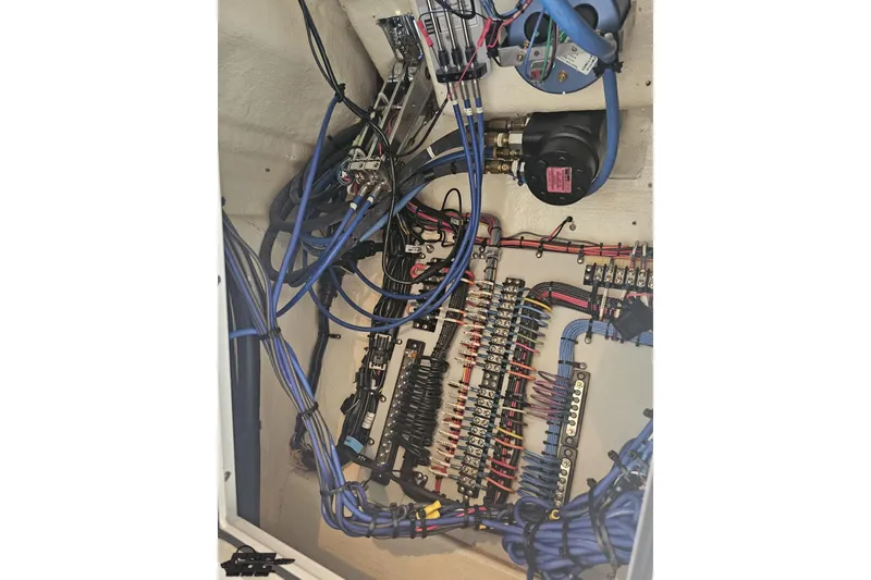 Slide: The Image of Electrical wiring and components inside a 2010 Hustler 266 Classic boat. - 76