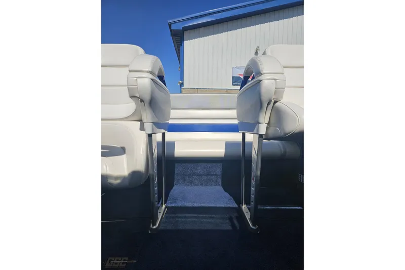 Slide: The Image of 2010 Hustler 266 Classic boat interior with white seats and blue carpet. - 77