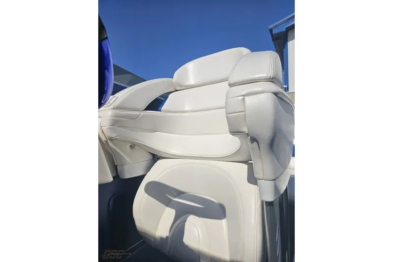 Slide: The Image of White leather seat on 2010 Hustler 266 Classic boat, under clear blue sky. - 80