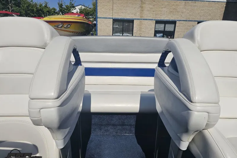 Slide: The Image of Interior of a 2010 Hustler 266 Classic boat with white leather seats. - 81