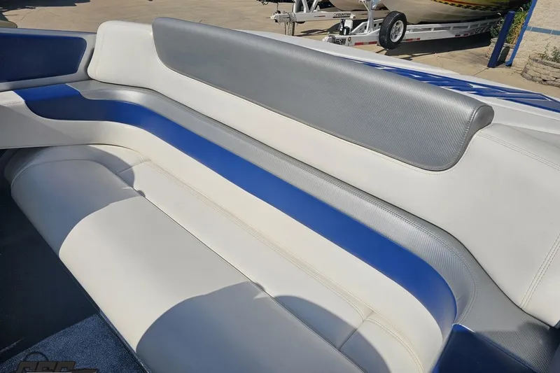 Slide: The Image of 2010 Hustler 266 Classic boat interior with blue and white seating. - 82