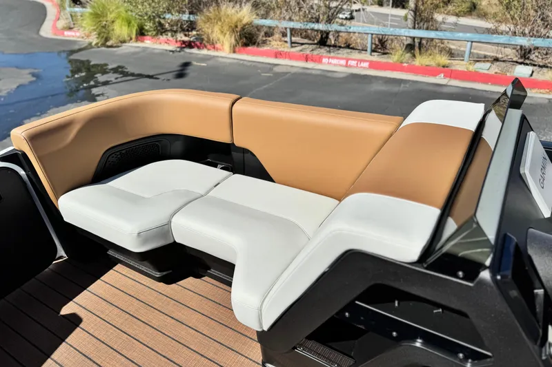 Slide: The Image of Luxurious seating on 2026 Manitou EXPLORE 22 boat, featuring tan and white upholstery. - 11