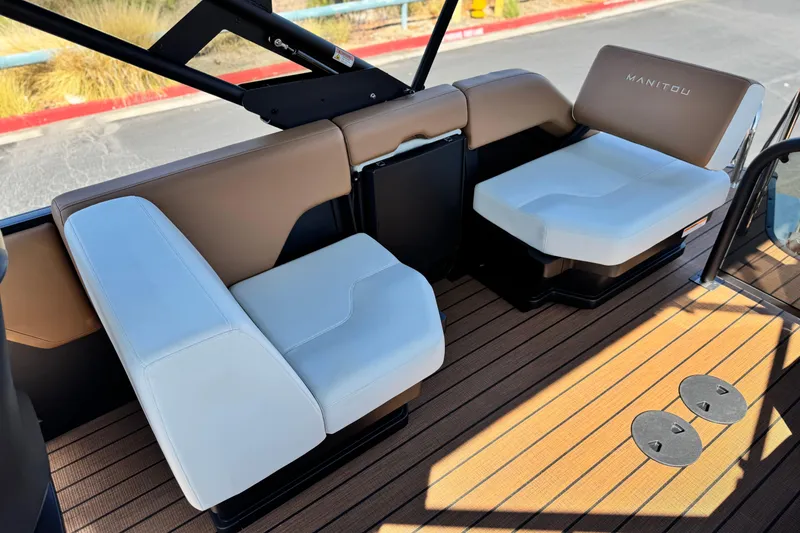 Slide: The Image of 2026 Manitou EXPLORE 22 boat interior with white and brown seating. - 15