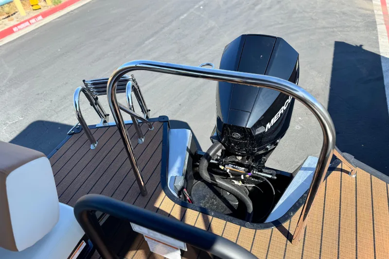 Slide: The Image of 2026 Manitou EXPLORE 22 boat with Mercury outboard motor and swim ladder. - 19