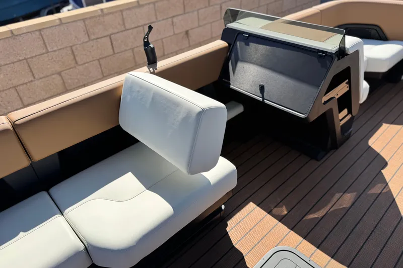 Slide: The Image of Interior of 2026 Manitou EXPLORE 22 boat with modern seating and dashboard. - 22