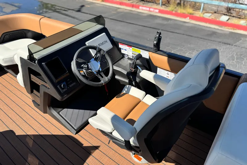 Slide: The Image of 2026 Manitou EXPLORE 22 boat cockpit with steering wheel and seating. - 23