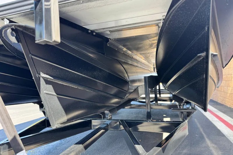Slide: The Image of Underneath view of 2026 Manitou EXPLORE 22 pontoon boat, showcasing its sleek black hull design. - 4