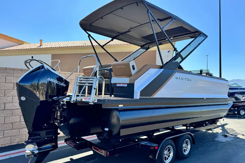 Slide: The Image of 2026 Manitou EXPLORE 22 pontoon boat with Mercury engine on trailer. - 6