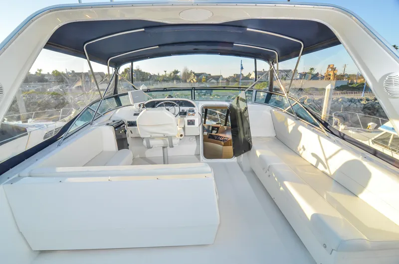 Slide: The Image of 2002 Bayliner 4788 Pilot House Motoryacht interior with spacious seating and helm station. - 10
