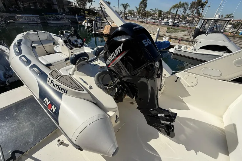 Slide: The Image of 2002 Bayliner 4788 Pilot House Motoryacht with Avon inflatable boat and Mercury 50 outboard. - 14