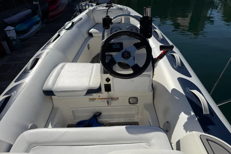 Slide: The Image of Interior view of a 2002 Bayliner 4788 Pilot House Motoryacht, featuring steering wheel and seating. - 15