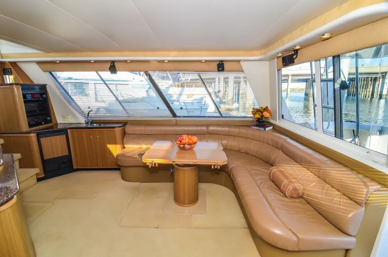 Slide: The Image of Luxurious interior of 2002 Bayliner 4788 Pilot House Motoryacht with leather seating and panoramic windows. - 23
