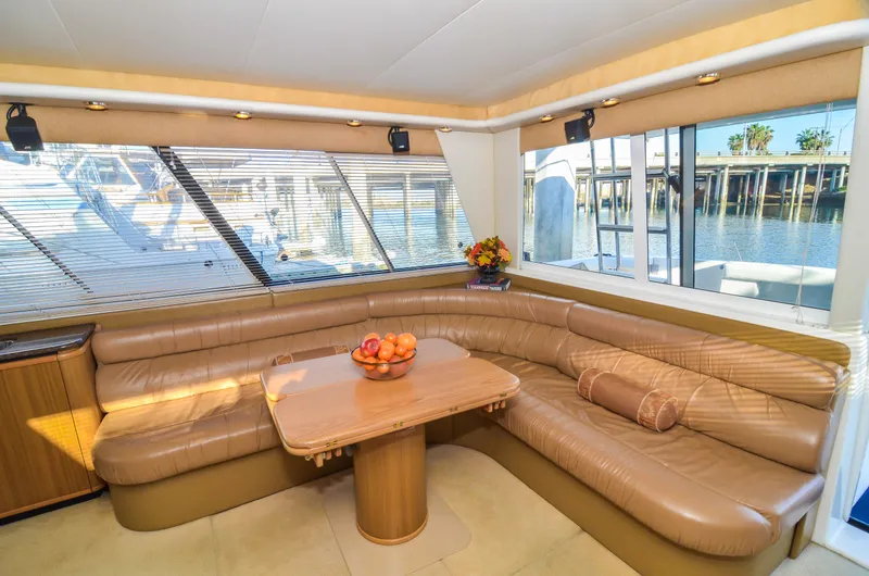 Slide: The Image of Luxurious interior of 2002 Bayliner 4788 Pilot House Motoryacht with leather seating and waterfront view. - 24