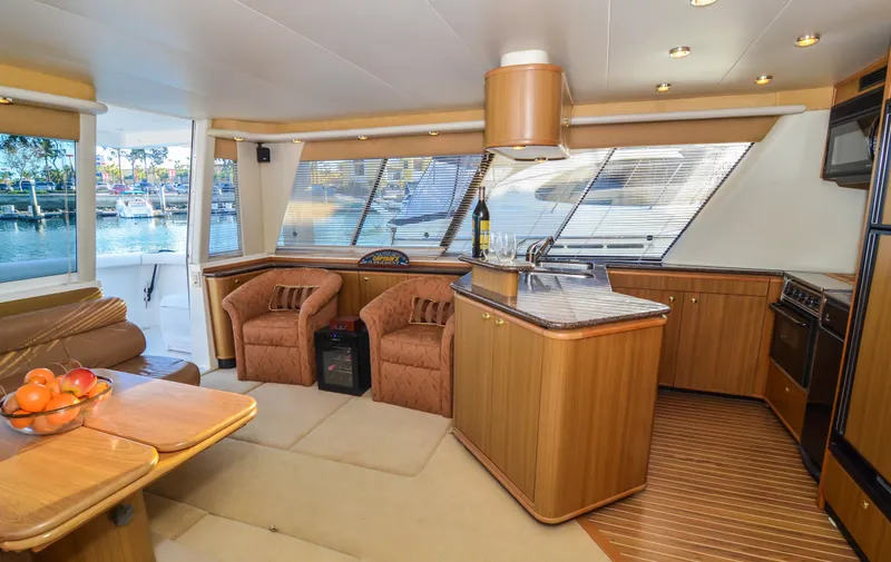 Slide: The Image of Luxurious interior of 2002 Bayliner 4788 Pilot House Motoryacht with modern kitchen and seating area. - 26