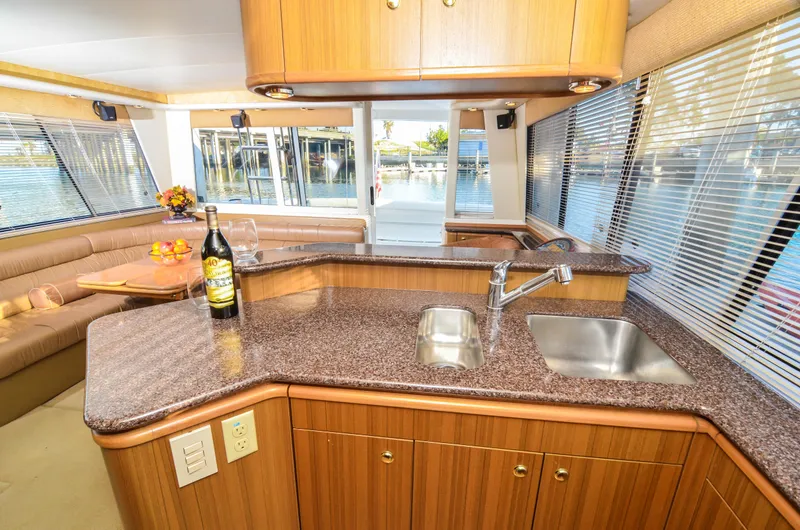 Slide: The Image of Luxurious 2002 Bayliner 4788 yacht interior with modern kitchen and scenic views. - 28