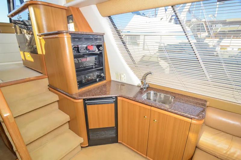 Slide: The Image of Luxurious interior of 2002 Bayliner 4788 Pilot House Motoryacht with kitchenette and stairs. - 29