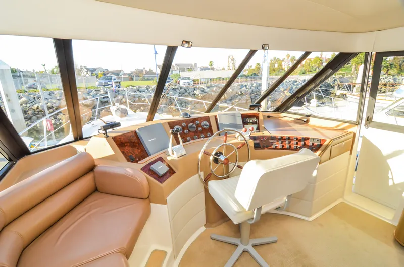 Slide: The Image of 2002 Bayliner 4788 Pilot House Motoryacht interior with helm, leather seating, and navigation equipment. - 32