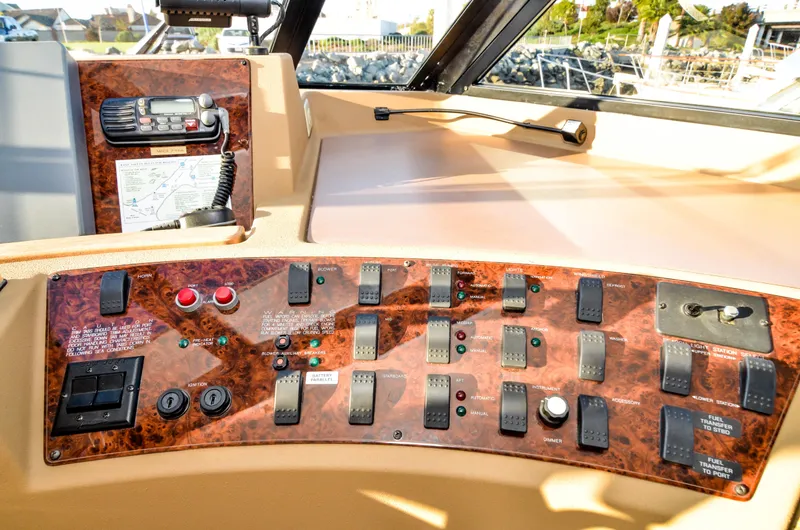 Slide: The Image of Control panel of 2002 Bayliner 4788 Pilot House Motoryacht with various switches and radio. - 36