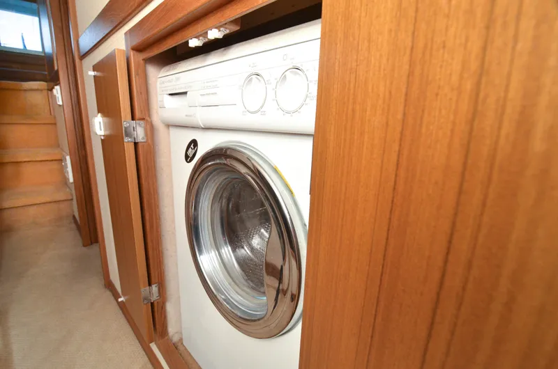 Slide: The Image of Washer in 2002 Bayliner 4788 Pilot House Motoryacht interior, wooden cabinetry. - 41