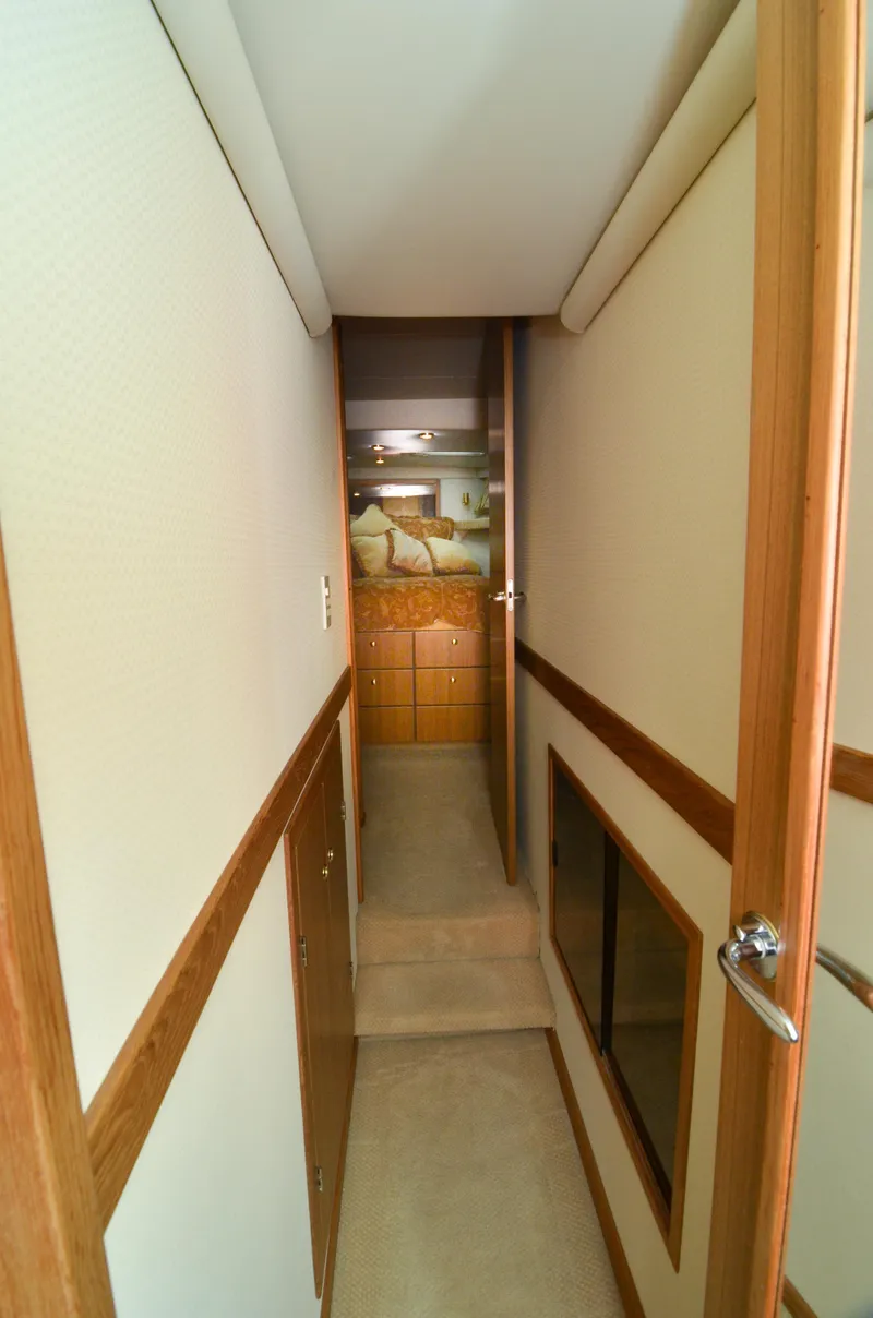 Slide: The Image of Narrow hallway inside 2002 Bayliner 4788 Pilot House Motoryacht, leading to a cozy cabin. - 42