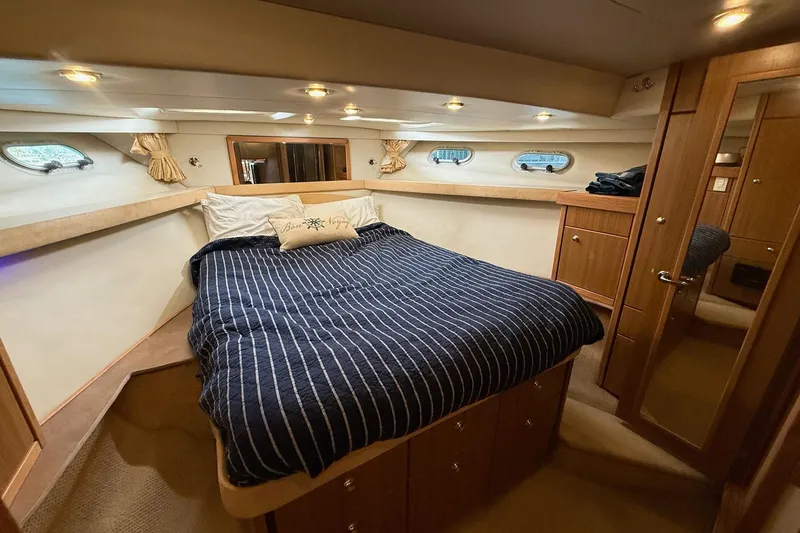 Slide: The Image of Luxurious bedroom in 2002 Bayliner 4788 Pilot House Motoryacht with striped bedding. - 44