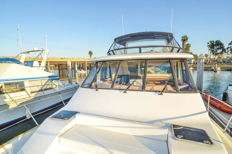 Slide: The Image of 2002 Bayliner 4788 Pilot House Motoryacht docked at marina under clear sky. - 5