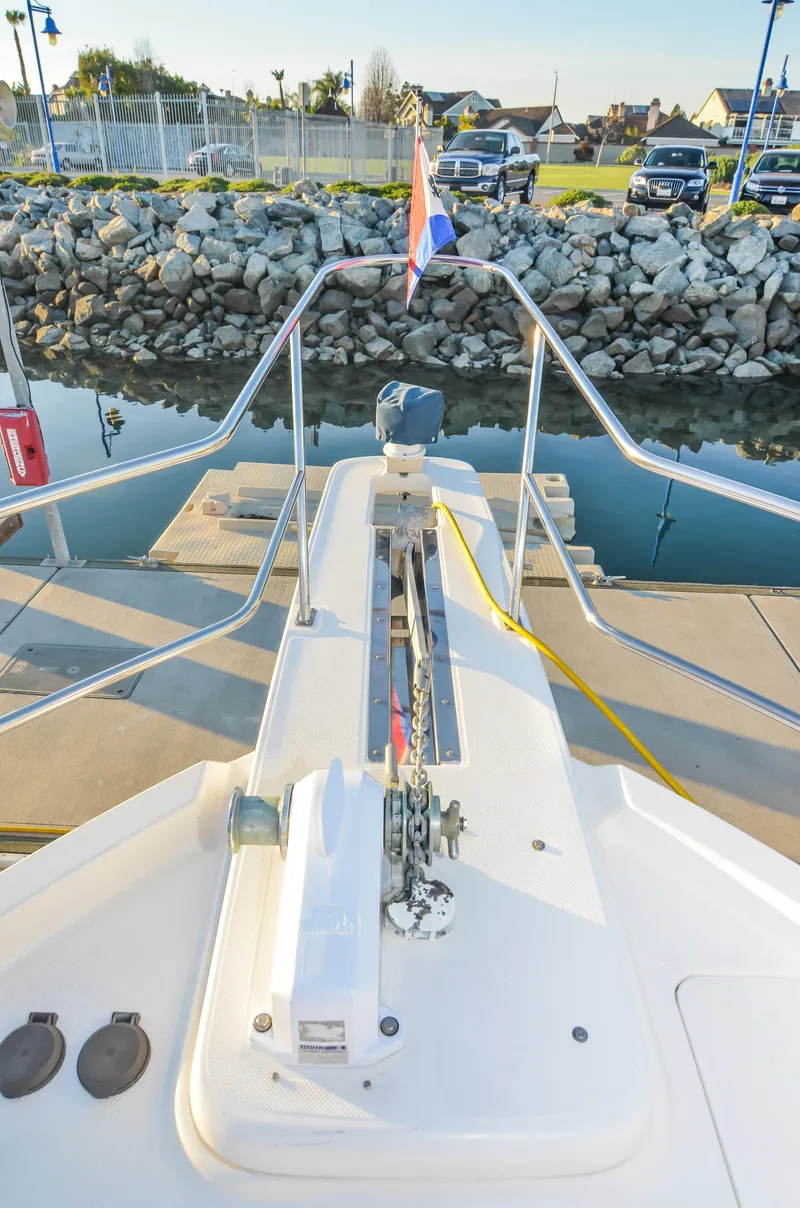 Slide: The Image of Bow view of 2002 Bayliner 4788 Pilot House Motoryacht docked at marina. - 6
