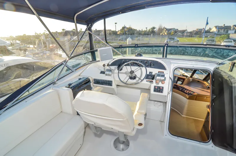 Slide: The Image of 2002 Bayliner 4788 Pilot House Motoryacht cockpit with steering wheel and navigation controls. - 8