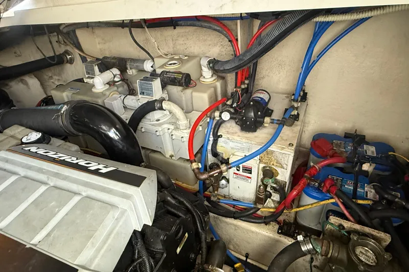 Slide: The Image of Engine compartment of 2008 Sea Ray 350 Sundancer with visible wiring and components. - 10