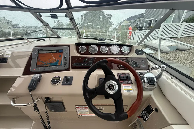 Slide: The Image of Cockpit of 2008 Sea Ray 350 Sundancer with navigation system and steering wheel. - 19