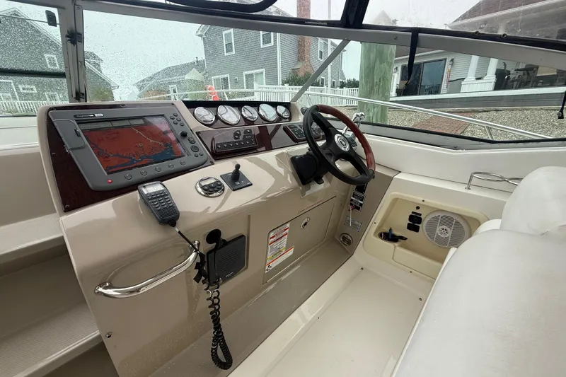 Slide: The Image of 2008 Sea Ray 350 Sundancer helm with navigation system and steering wheel. - 20