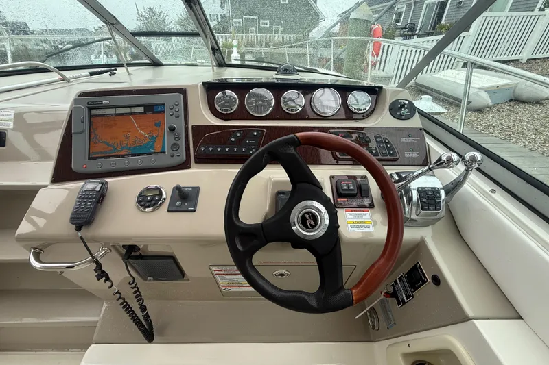 Slide: The Image of Cockpit of 2008 Sea Ray 350 Sundancer with navigation system and controls. - 22