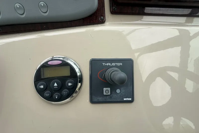 Slide: The Image of Control panel of a 2008 Sea Ray 350 Sundancer with audio and thruster controls. - 25