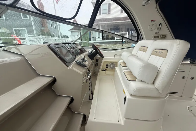 Slide: The Image of Interior cockpit of 2008 Sea Ray 350 Sundancer with white seating and control panel. - 27