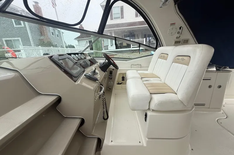 Slide: The Image of 2008 Sea Ray 350 Sundancer helm with dual seats, steering wheel, and control panel. - 28