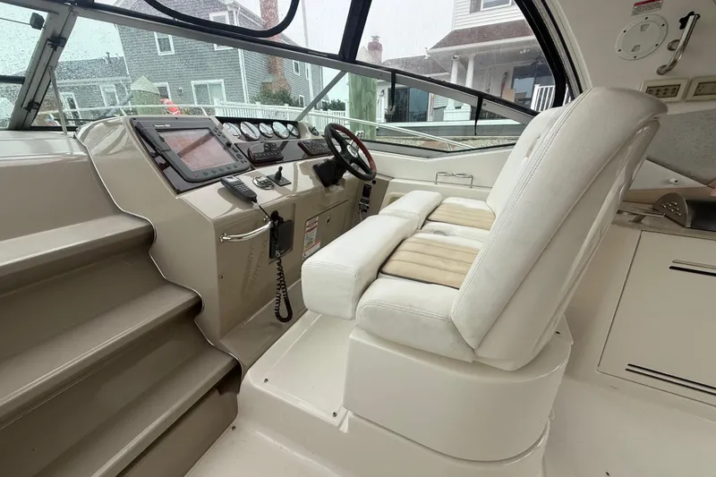 Slide: The Image of 2008 Sea Ray 350 Sundancer helm with white seating and modern controls. - 29