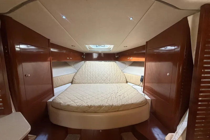 Slide: The Image of Luxurious cabin interior of 2008 Sea Ray 350 Sundancer with cozy bed and wood finish. - 7