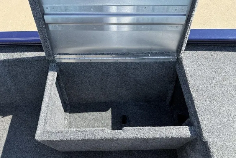 Slide: The Image of Open storage compartment in 2020 Tracker Pro 170 boat, featuring carpeted interior. - 10