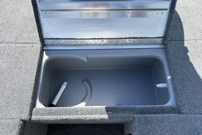 Slide: The Image of 2020 Tracker Pro 170 boat storage compartment with open lid, showing interior details. - 12