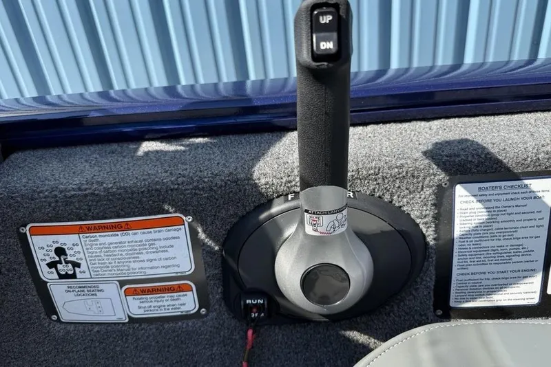 Slide: The Image of 2020 Tracker Pro 170 boat control panel with warning labels and checklist. - 18