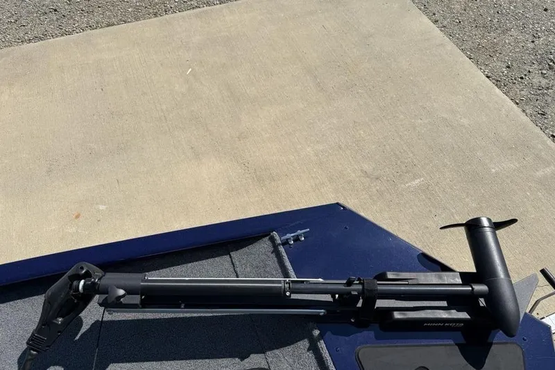 Slide: The Image of 2020 Tracker Pro 170 boat with a mounted trolling motor on a concrete surface. - 4