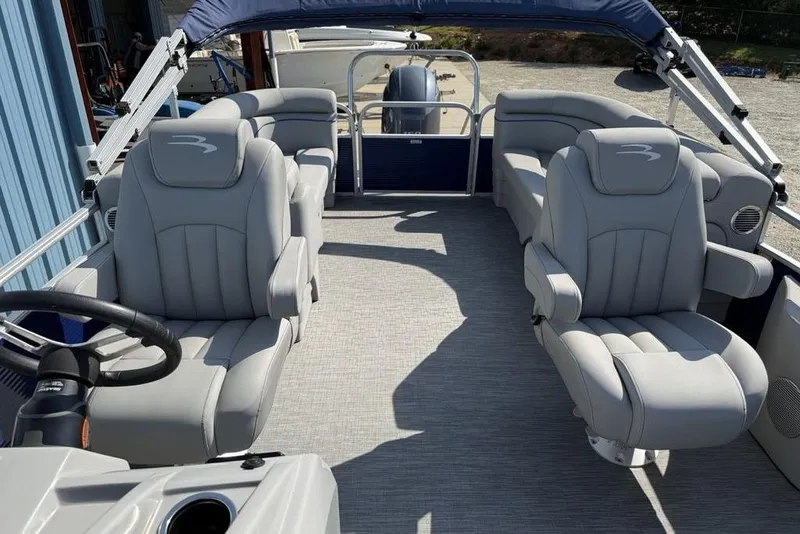 Slide: The Image of 2023 Bennington 22 boat interior with plush gray seating and steering wheel. - 10