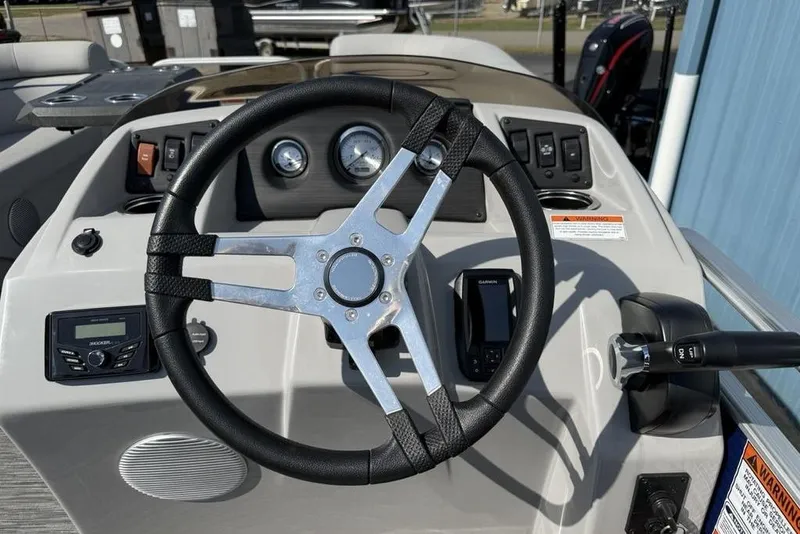 Slide: The Image of 2023 Bennington 22 boat dashboard with steering wheel and control panel. - 11