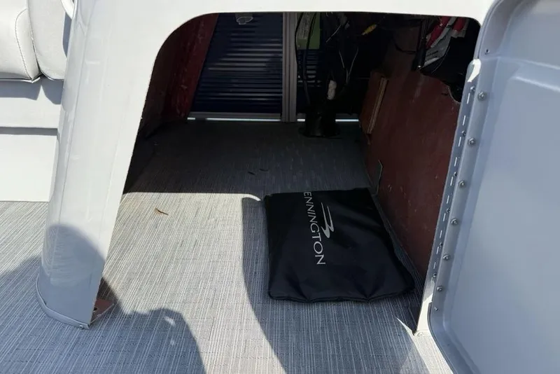 Slide: The Image of 2023 Bennington 22 boat interior storage area with branded mat. - 12